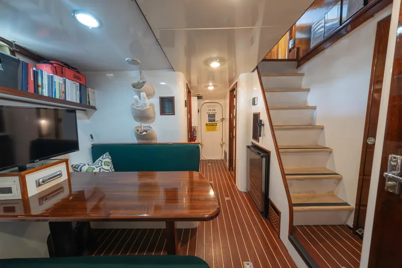 Slide: The Image of Interior of 1939 Mathis Trumpy Fantail Houseboat with wooden table and staircase. - 20