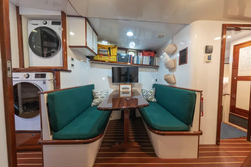Slide: The Image of Interior of 1939 Mathis Trumpy Fantail Houseboat with green seating and laundry appliances. - 21