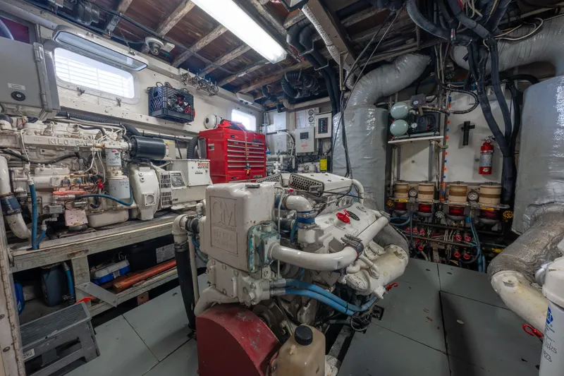 Slide: The Image of Engine room of a 1939 Mathis Trumpy Fantail Houseboat, featuring machinery and tools. - 26