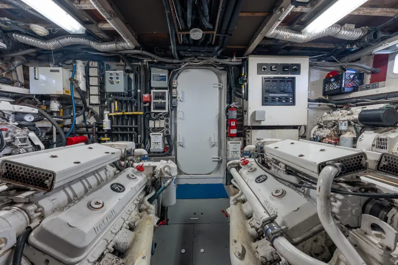 Slide: The Image of Engine room of a 1939 Mathis Trumpy Fantail Houseboat, featuring vintage machinery and control panels. - 28