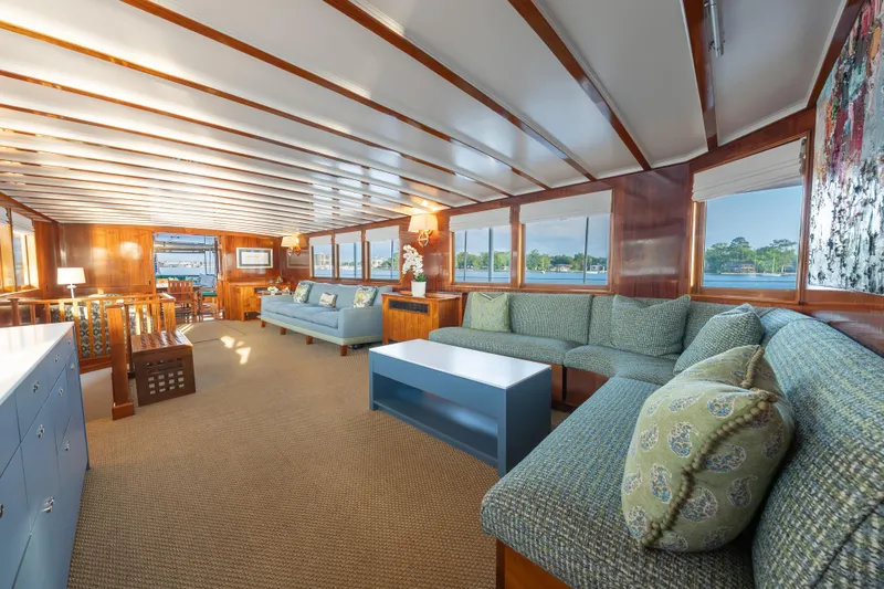 Slide: The Image of Luxurious 1939 Mathis Trumpy Fantail Houseboat interior with elegant wood paneling and plush seating. - 3