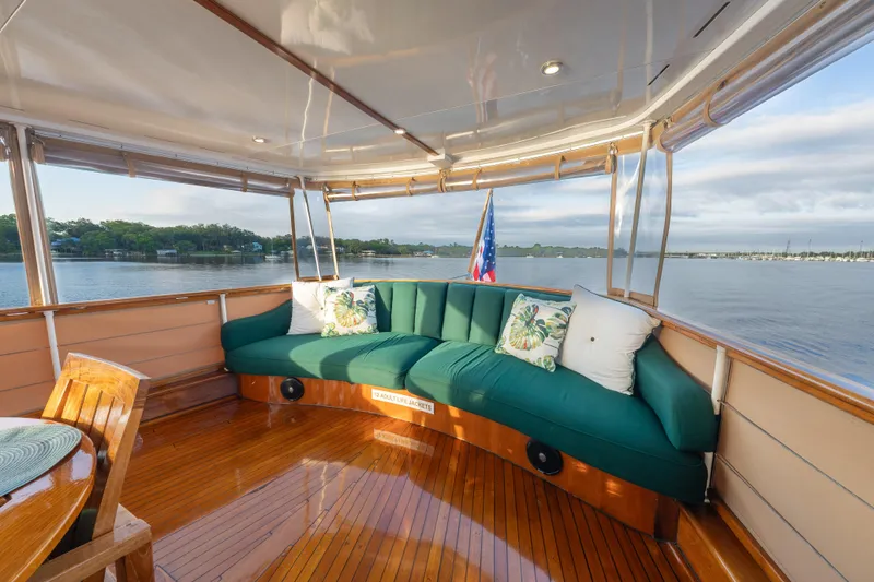 Slide: The Image of Elegant 1939 Trumpy Fantail Houseboat interior with plush seating and scenic water views. - 32