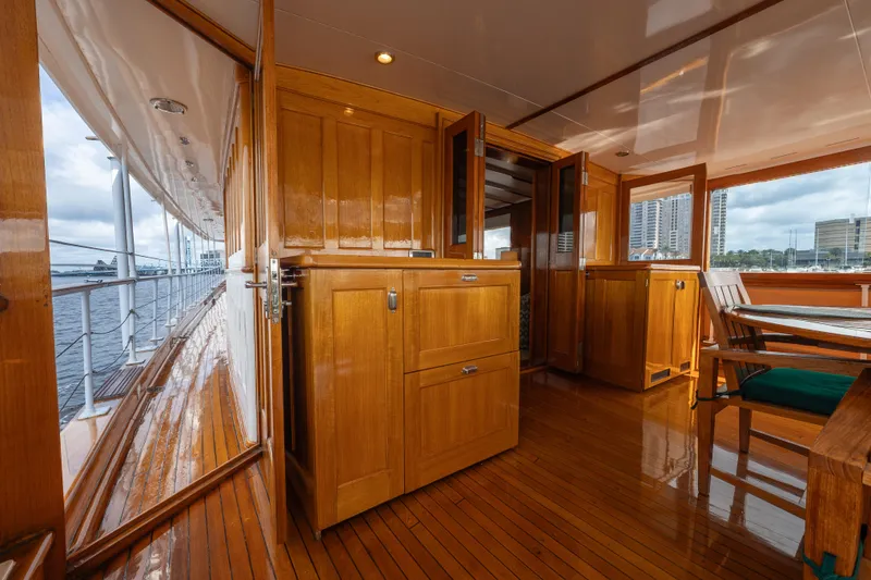 Slide: The Image of 1939 Mathis Trumpy Fantail Houseboat interior with polished wood and waterfront view. - 33