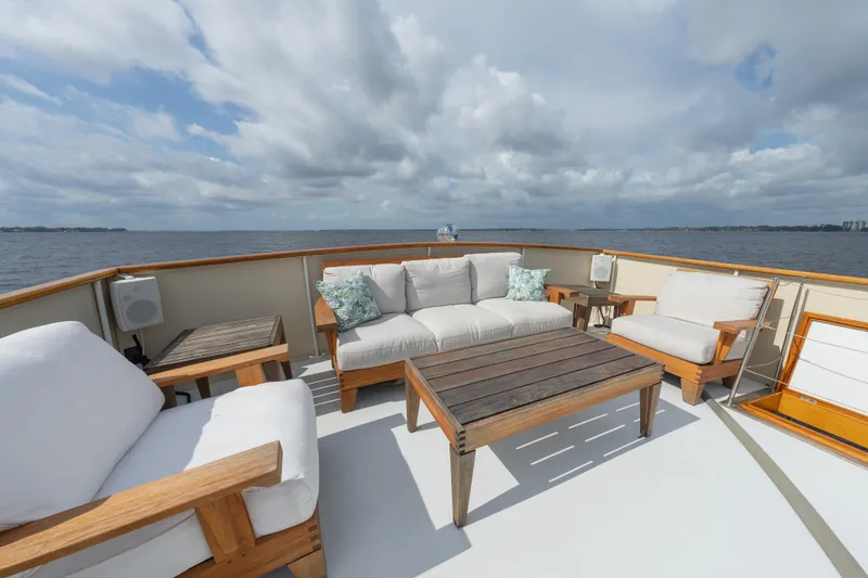 Slide: The Image of Luxurious deck seating on 1939 Mathis Trumpy Fantail Houseboat, overlooking serene waters. - 36