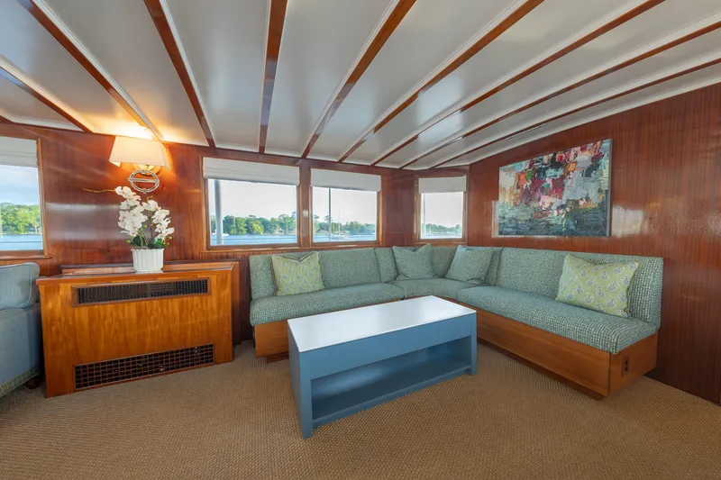 Slide: The Image of Interior of 1939 Mathis Trumpy Fantail Houseboat with cozy seating and elegant decor. - 4