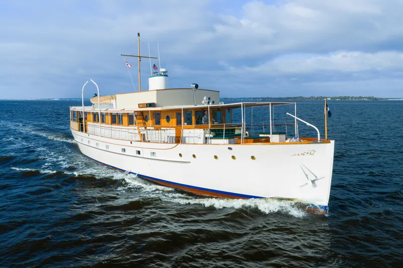 Slide: The Image of 1939 Mathis Trumpy Fantail Houseboat cruising on open water under a cloudy sky. - 40