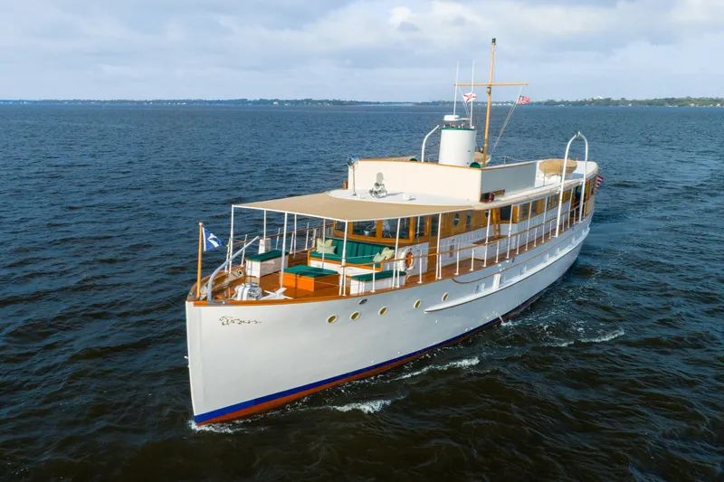 Slide: The Image of 1939 Mathis Trumpy Fantail Houseboat cruising on open water under a cloudy sky. - 42