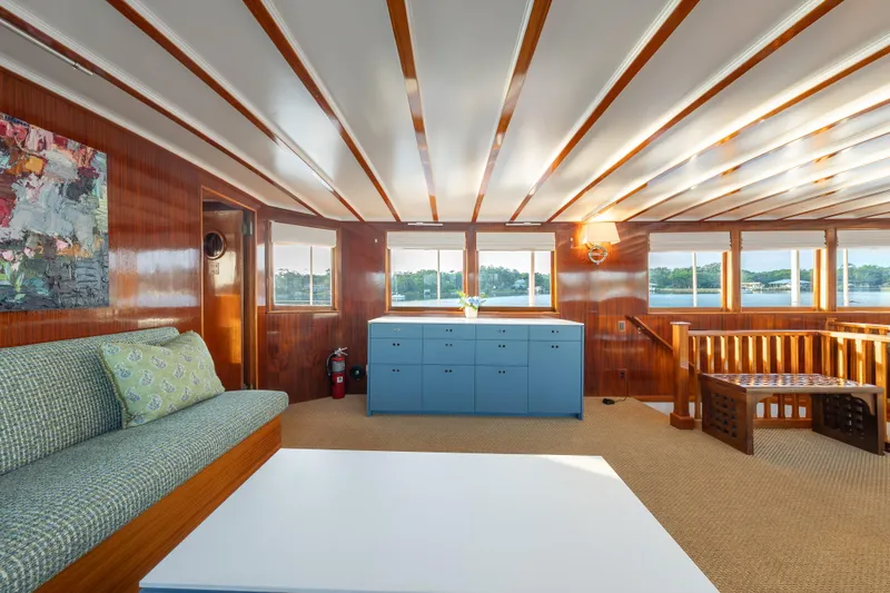 Slide: The Image of Luxurious 1939 Trumpy Fantail Houseboat interior with elegant wood paneling and scenic windows. - 5