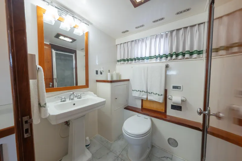 Slide: The Image of Luxurious bathroom in 1939 Mathis Trumpy Fantail Houseboat with elegant fixtures and decor. - 8