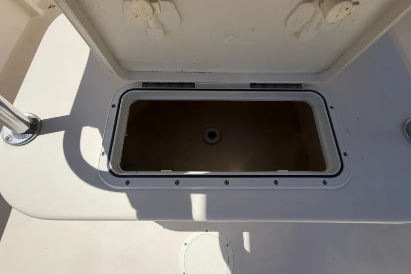 Slide: The Image of Open storage compartment on a 2006 Parker 23SE Center Console boat. - 12