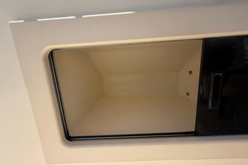 Slide: The Image of Empty storage compartment on a 2006 Parker 23SE Center Console boat. - 14