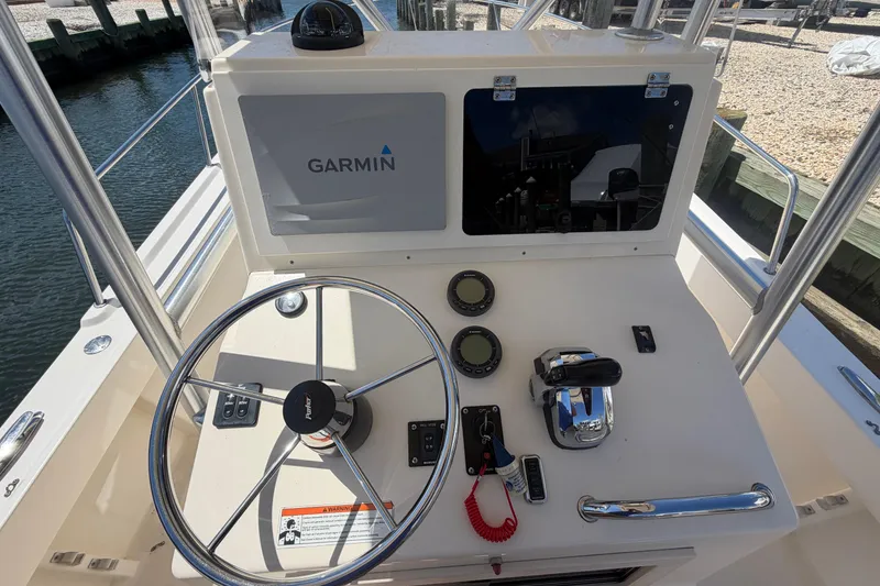 Slide: The Image of 2006 Parker 23SE Center Console boat dashboard with Garmin navigation system. - 17
