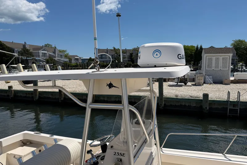 Slide: The Image of 2006 Parker 23SE Center Console boat docked near waterfront homes. - 21