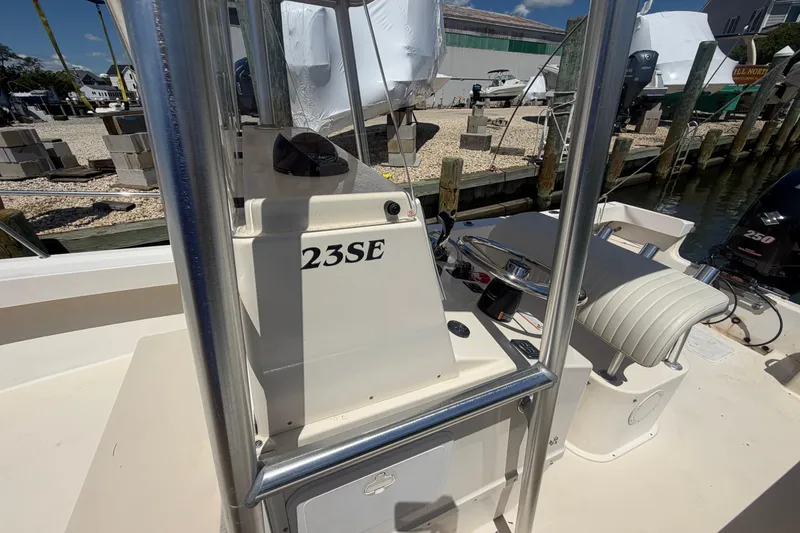 Slide: The Image of 2006 Parker 23SE Center Console boat docked at a marina, featuring steering console. - 23