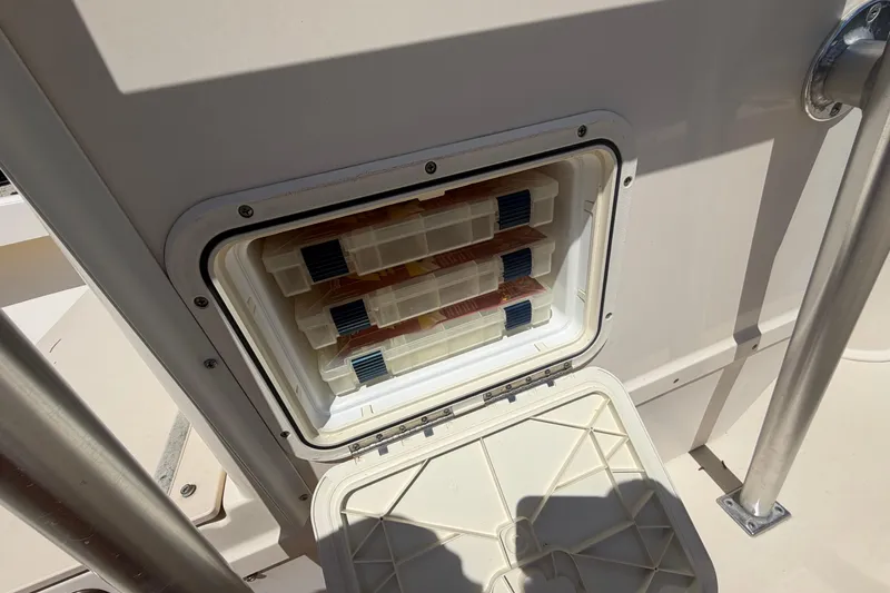 Slide: The Image of Open storage compartment on a 2006 Parker 23SE Center Console boat. - 24