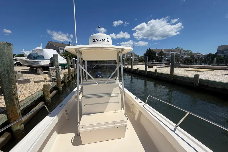 Slide: The Image of 2006 Parker 23SE Center Console boat docked, featuring Garmin equipment, under a clear blue sky. - 25