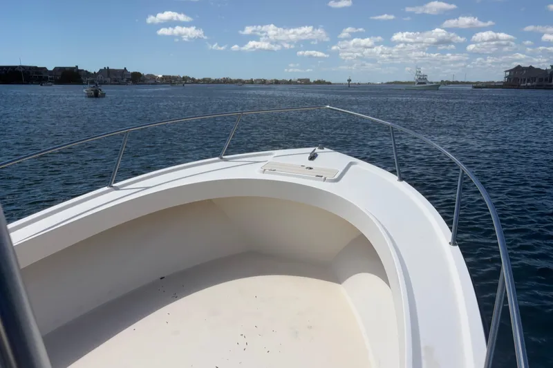 Slide: The Image of 2006 Parker 23SE Center Console boat on calm water under blue sky. - 28