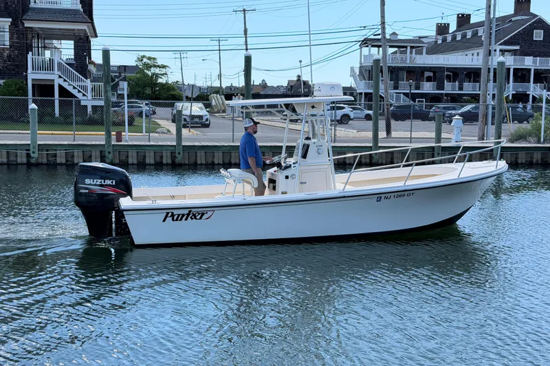 Slide: The Image of 2006 Parker 23SE Center Console boat with Suzuki outboard motor on calm water. - 3