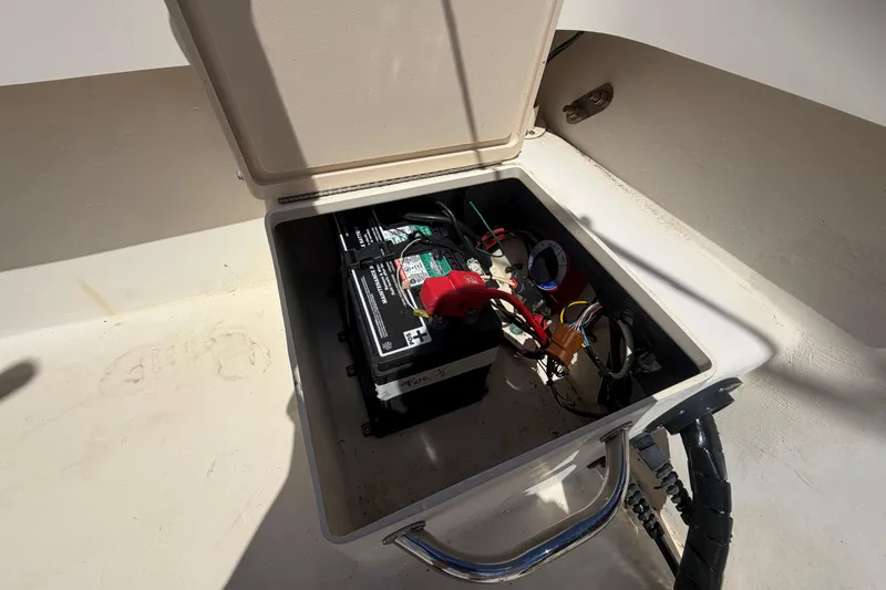 Slide: The Image of Battery compartment of a 2006 Parker 23SE Center Console boat, showing wiring and connections. - 9