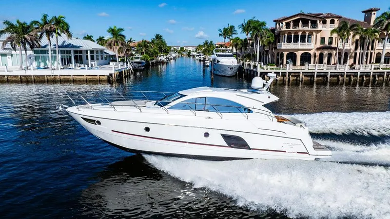 Slide: The Image of 2016 Beneteau GRAN TURISMO 49 yacht cruising in a scenic waterfront setting. - 10