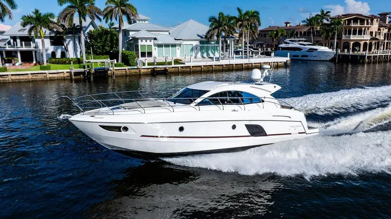 Slide: The Image of 2016 Beneteau GRAN TURISMO 49 yacht cruising on a sunny waterfront. - 11