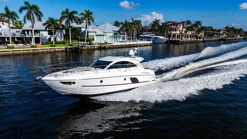 Slide: The Image of 2016 Beneteau GRAN TURISMO 49 yacht cruising on a sunny waterfront. - 12