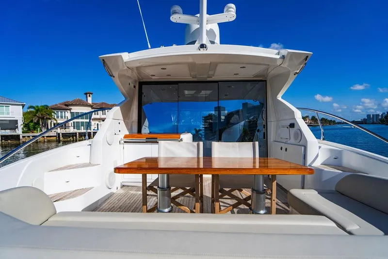 Slide: The Image of 2016 Beneteau Gran Turismo 49 yacht with outdoor seating, docked by waterfront homes. - 22