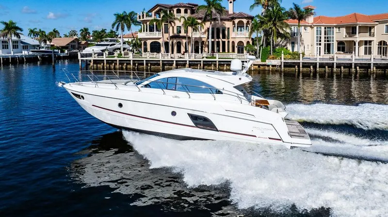 Slide: The Image of 2016 Beneteau GRAN TURISMO 49 yacht cruising near luxury waterfront homes. - 3