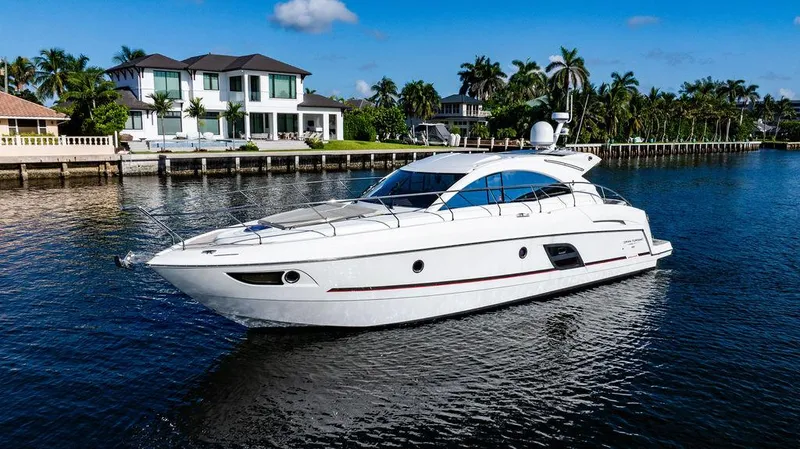 Slide: The Image of 2016 Beneteau Gran Turismo 49 yacht cruising near waterfront homes. - 4