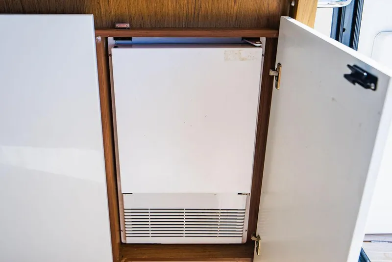 Slide: The Image of Beneteau Gran Turismo 49 yacht interior fridge, 2016 model, wooden cabinet. - 41