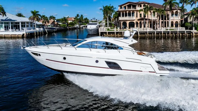 Slide: The Image of 2016 Beneteau GRAN TURISMO 49 yacht cruising in a scenic waterfront setting. - 9