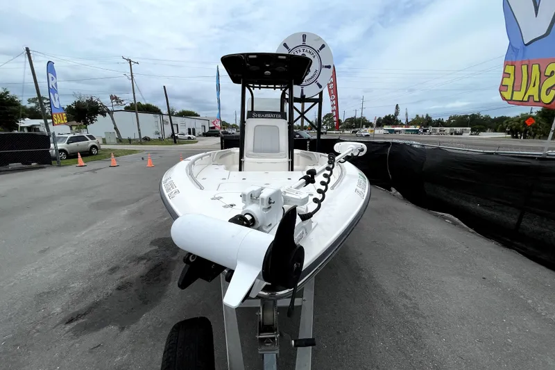 Slide: The Image of 2019 ShearWater 25 LTZ boat on trailer at outdoor sale event. - 10