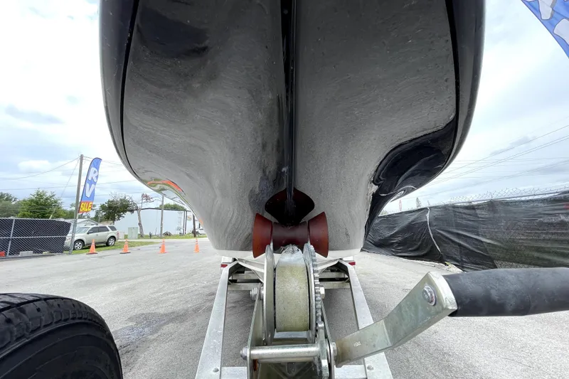 Slide: The Image of 2019 ShearWater 25 LTZ boat on trailer, viewed from below, showcasing hull design. - 12