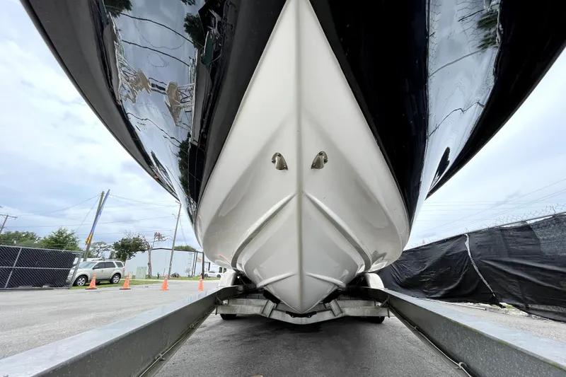 Slide: The Image of 2019 ShearWater 25 LTZ boat on trailer, viewed from below, showcasing sleek hull design. - 13