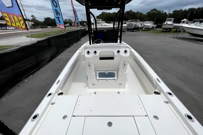 Slide: The Image of 2019 ShearWater 25 LTZ boat interior, showcasing spacious deck and seating area. - 14
