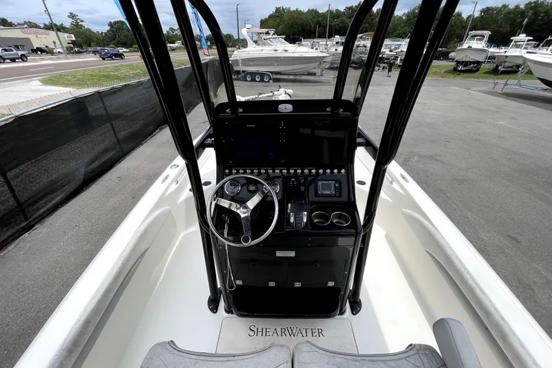 Slide: The Image of 2019 ShearWater 25 LTZ boat dashboard with steering wheel and controls. - 17