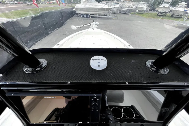 Slide: The Image of 2019 ShearWater 25 LTZ boat dashboard with Simrad display and Minn Kota equipment. - 19