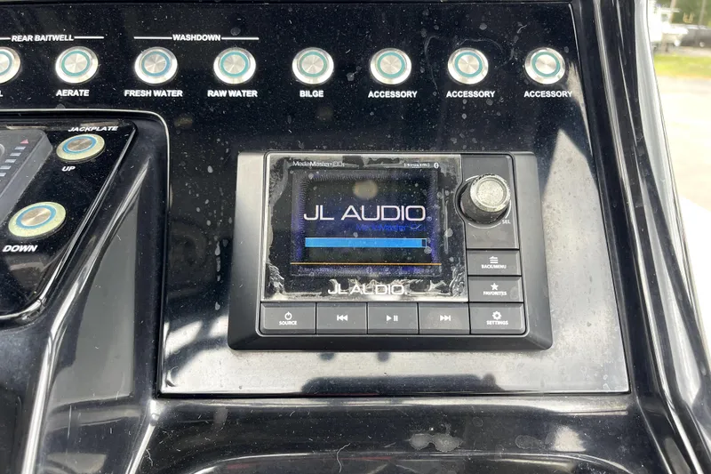 Slide: The Image of Control panel of a 2019 ShearWater 25 LTZ boat featuring JL Audio system. - 26