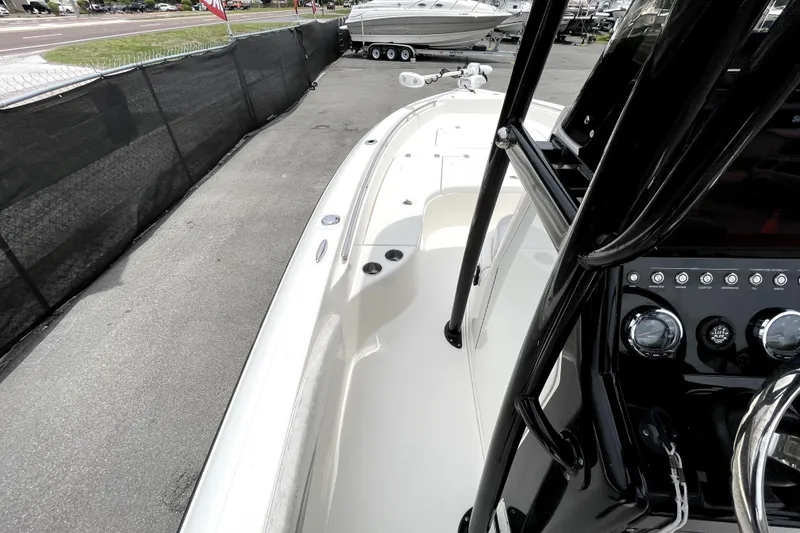 Slide: The Image of 2019 ShearWater 25 LTZ boat interior with control panel and seating area. - 27
