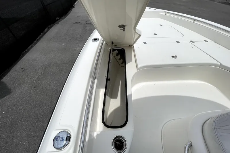Slide: The Image of 2019 ShearWater 25 LTZ boat deck with open storage compartment. - 31