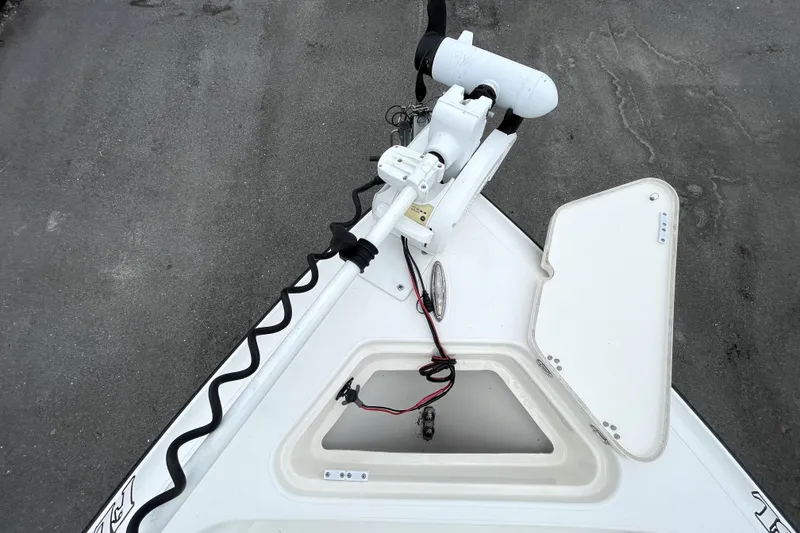 Slide: The Image of 2019 ShearWater 25 LTZ boat bow with trolling motor and open storage compartment. - 35