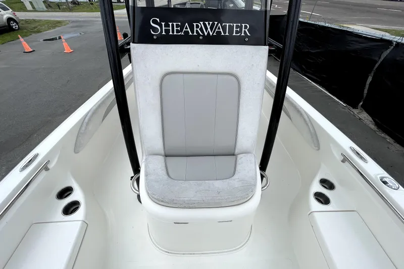 Slide: The Image of 2019 ShearWater 25 LTZ boat interior with cushioned seating and cup holders. - 38