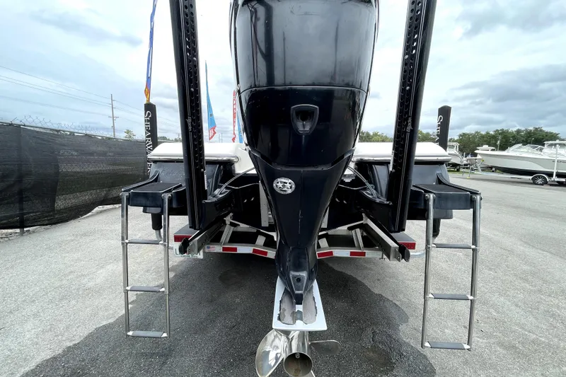 Slide: The Image of 2019 ShearWater 25 LTZ boat rear view with dual ladders and motor. - 4