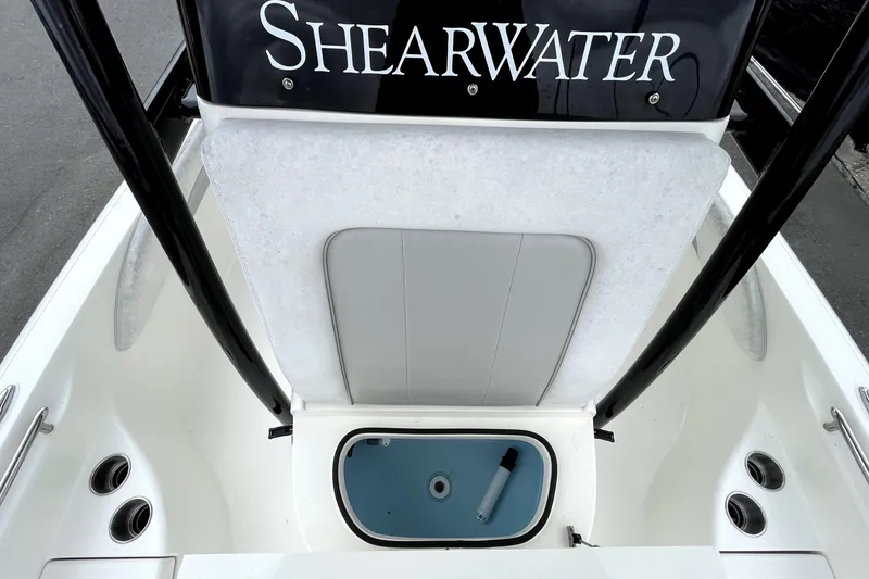 Slide: The Image of 2019 ShearWater 25 LTZ boat interior with storage compartment and seating. - 40