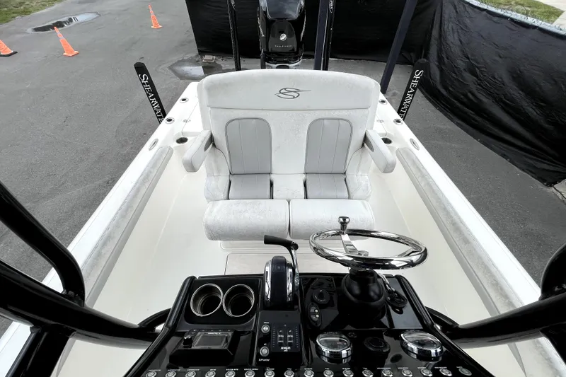 Slide: The Image of 2019 ShearWater 25 LTZ boat interior with steering wheel and seating. - 44