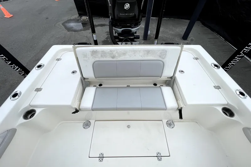 Slide: The Image of 2019 ShearWater 25 LTZ boat interior with seating and storage compartments. - 49