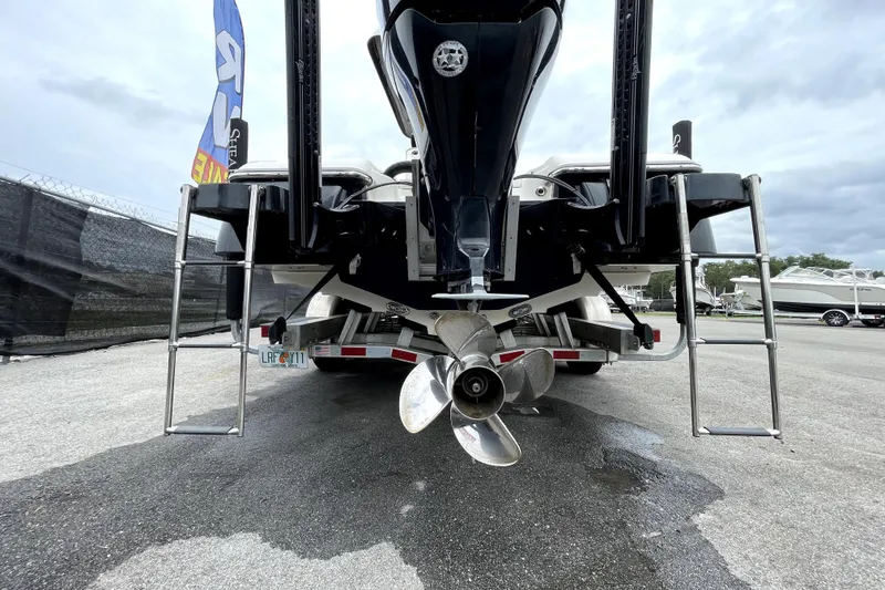 Slide: The Image of 2019 ShearWater 25 LTZ boat rear view with propeller and ladders. - 5