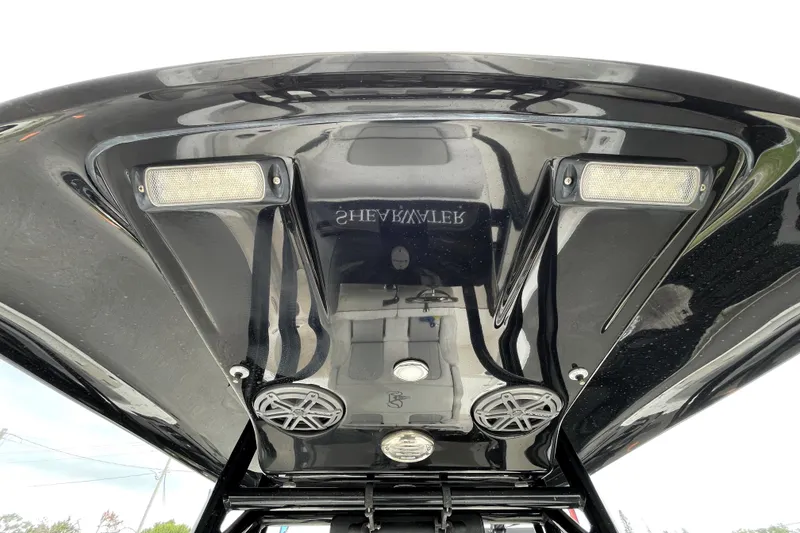 Slide: The Image of 2019 ShearWater 25 LTZ boat's sleek black T-top with integrated speakers and lights. - 52