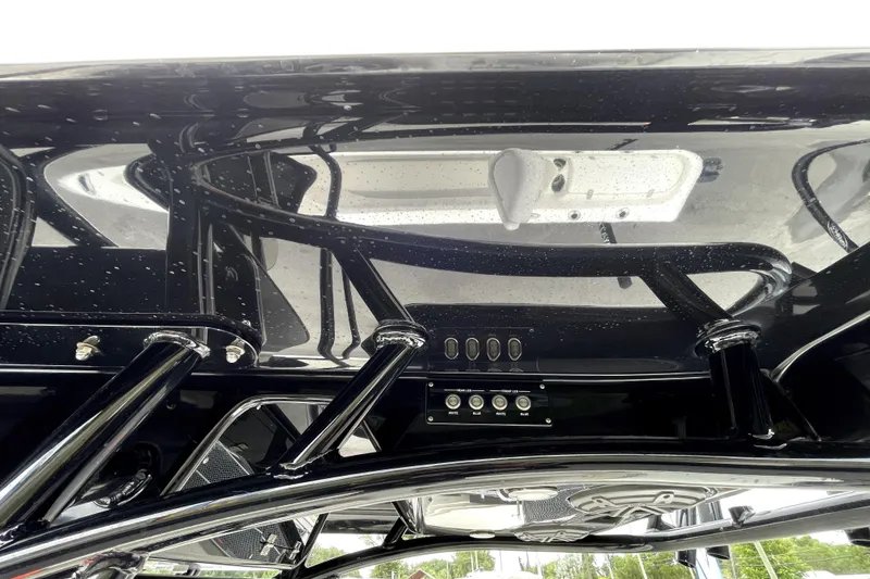 Slide: The Image of 2019 ShearWater 25 LTZ boat's sleek black T-top with integrated controls. - 53