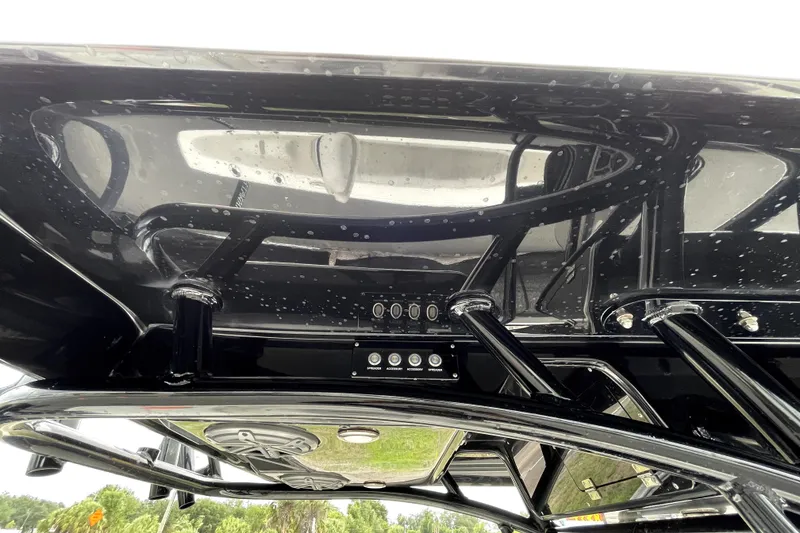 Slide: The Image of 2019 ShearWater 25 LTZ boat's sleek black T-top with integrated controls. - 54